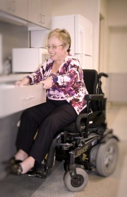 lady with complex care needs in the kitchen on wheelchair